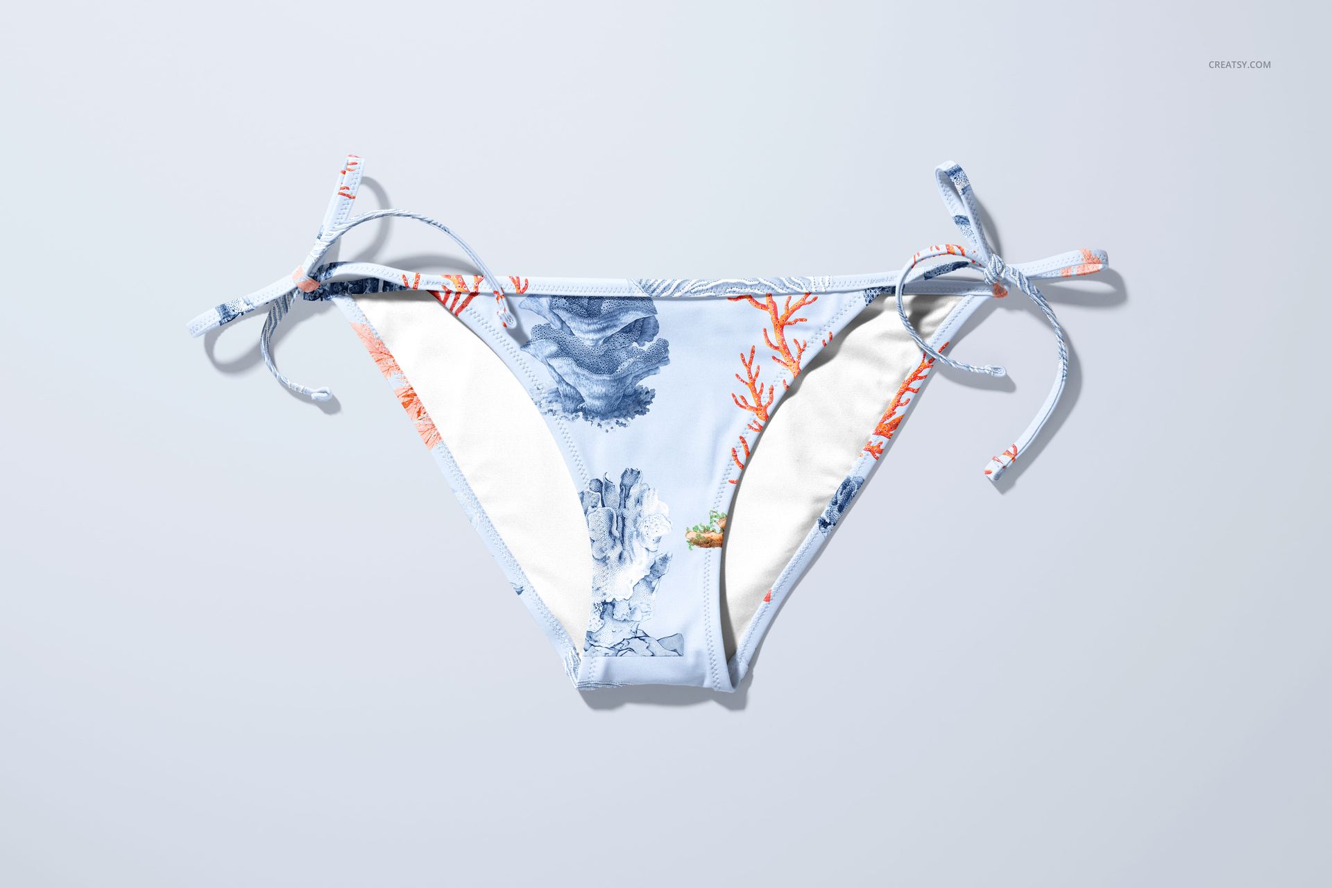 Front view of bikini bottom mockup with blue and orange coral pattern, displayed on a light background.