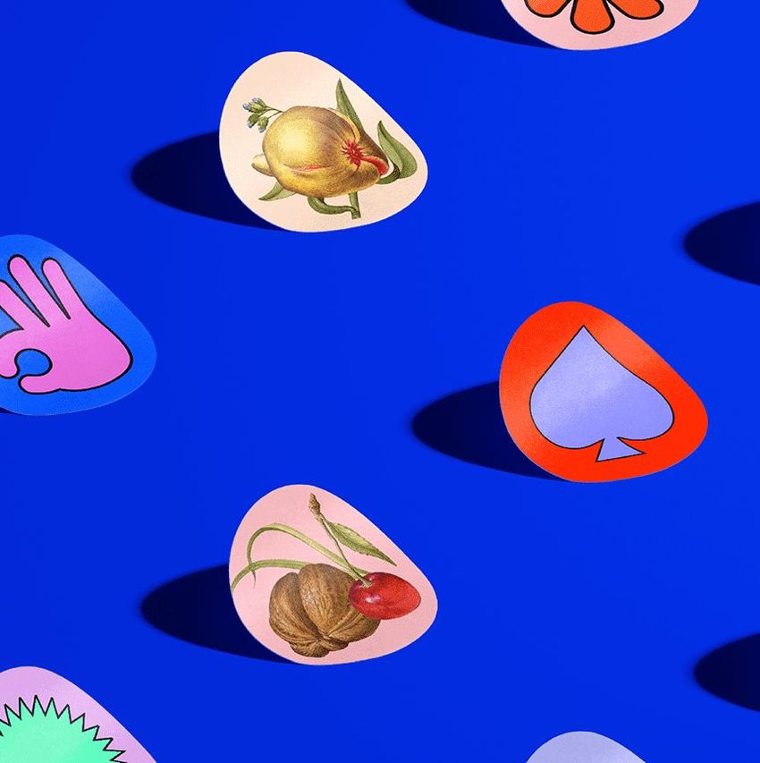 Sticker mockup featuring various colorful, irregularly shaped stickers with fruit illustrations and graphic symbols on a blue background.