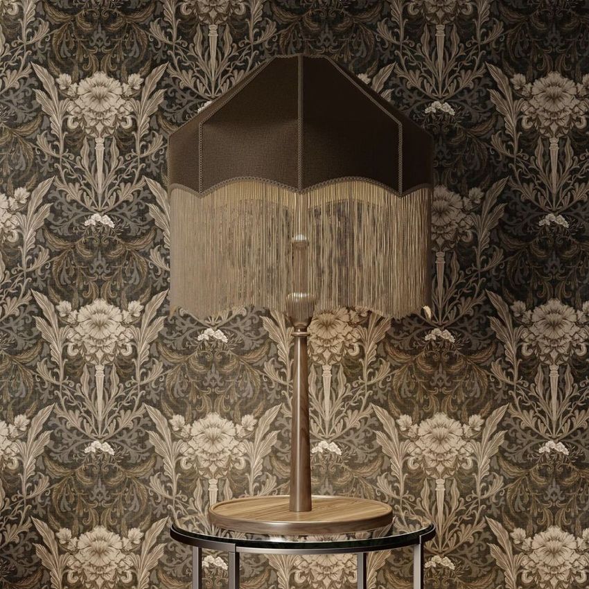 Table lamp mockup with a dark brown tassel shade displayed on a round side table against a floral damask wallpaper.