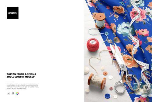 Close-up of vibrant blue floral cotton fabric mockup with sewing accessories like thread spools, buttons, and measuring tape.