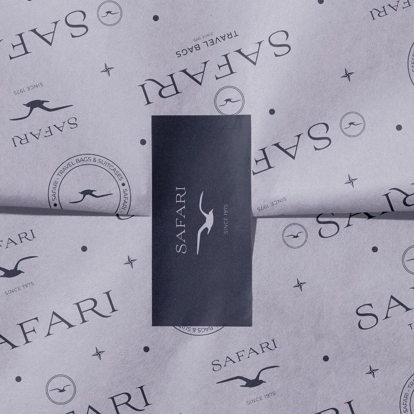 Wrapping paper mockup with a safari-themed design in black on light purple, featuring a rectangular sticker in the center.