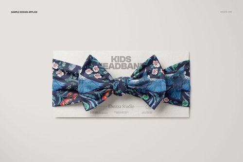Mockup of a kids bow tie headband featuring a vibrant blue design with birds and flowers, shown from above on a display card.