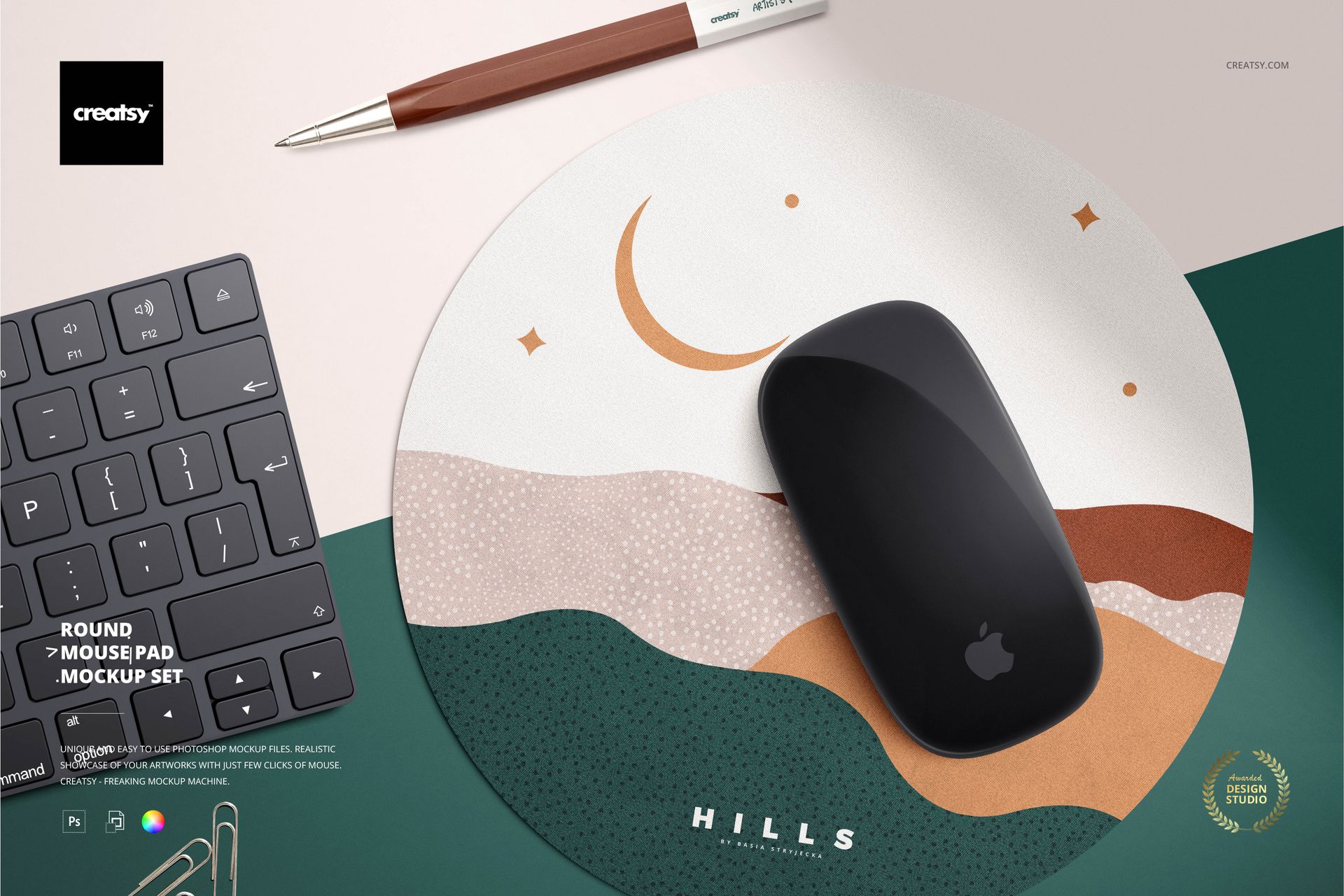 PSD mockup of a circular mouse pad featuring a wavy pattern, placed beside a keyboard, pen, and mouse.