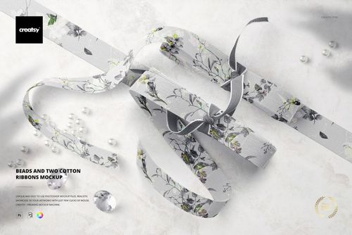 Top view of two cotton ribbons with floral patterns and scattered beads on a light marble surface, PSD mockup scene.