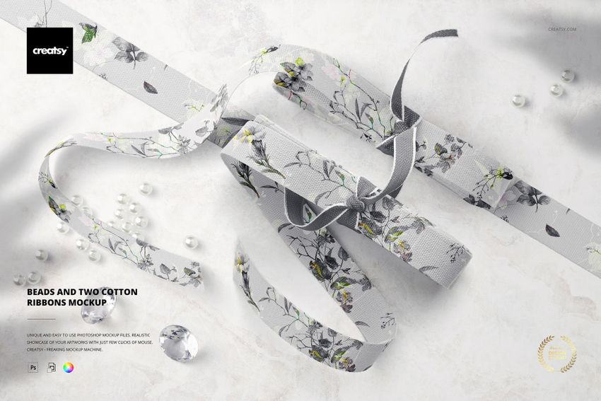 Top view of two cotton ribbons with floral patterns and scattered beads on a light marble surface, PSD mockup scene.