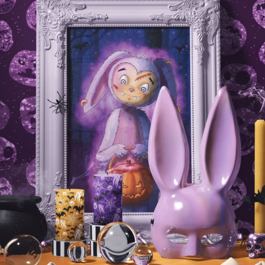 Halloween picture frame mockup featuring a spooky bunny illustration with stitched face, surrounded by themed props and candles.