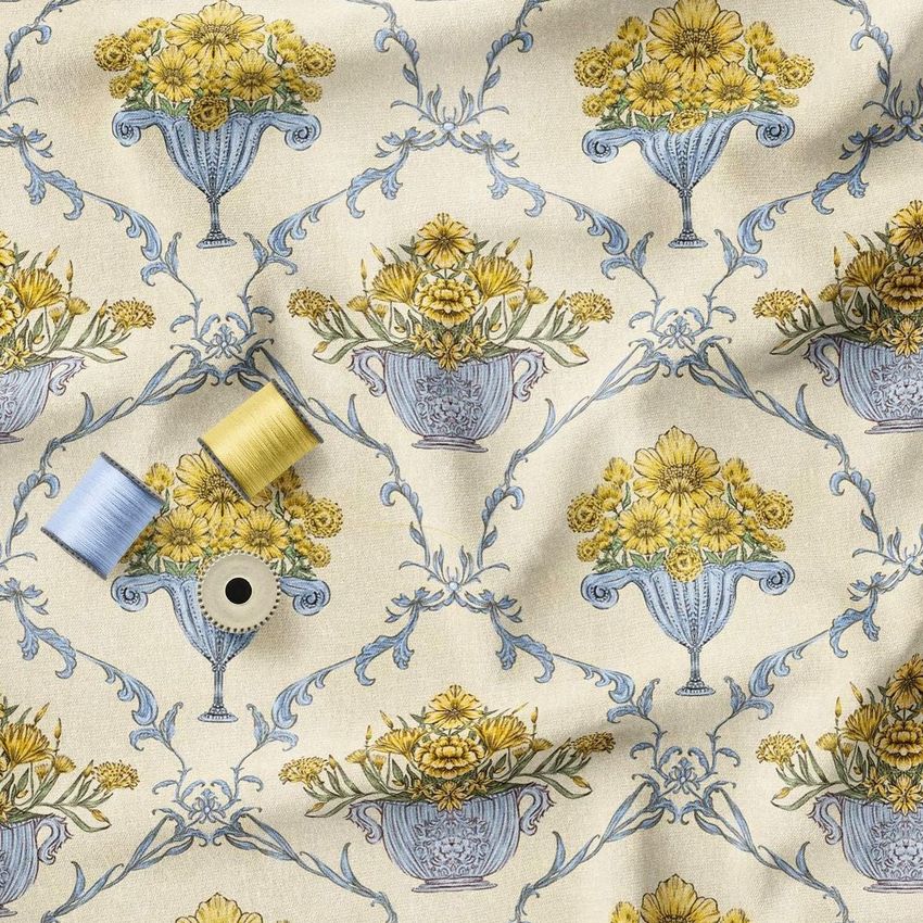 Creased fabric mockup featuring a repeating pattern of blue vases filled with yellow flowers, with sewing threads on top.