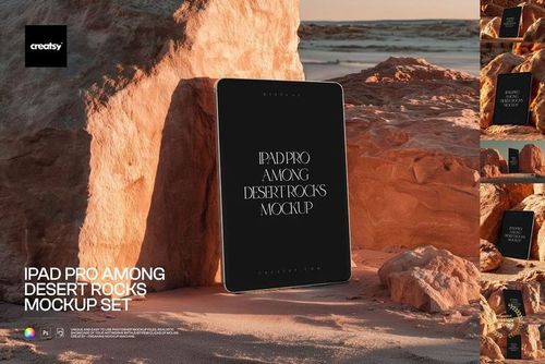 PSD mockup of an iPad Pro positioned vertically among desert rocks, illuminated by warm sunlight and surrounded by sand.