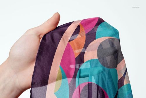 Habotai silk scarf mockup displaying vibrant overlapping circles and curves, held in hand, detailed texture visible.