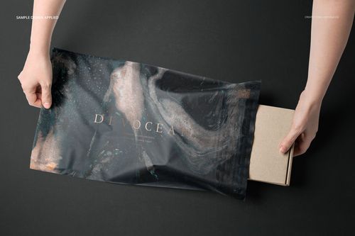 Noissue Mailing Box Mockup Set v.2 showing a cardboard box being inserted into a patterned mailer bag, top perspective.