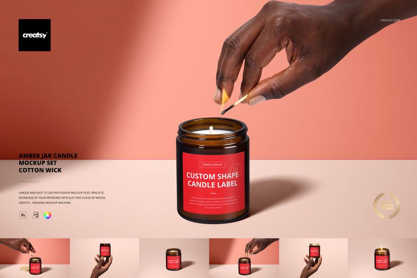 PSD mockup of amber jar candle with cotton wick, hand about to light candle, pink surface and background, close-up.