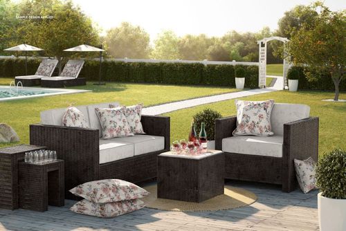 PSD mockup of outdoor rattan furniture featuring white cushions, floral pillows, and garden scenery with pool.