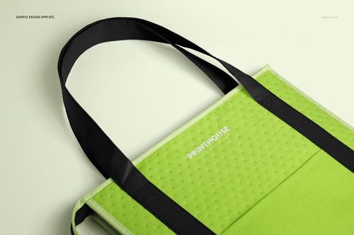 Close-up of a green Therm-O-Tote cooler bag mockup with black straps, showing a dotted texture and minimal branding.