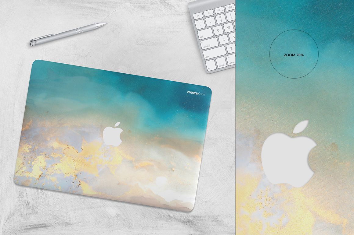 PSD mockup of a Macbook with a marble-inspired skin, viewed from above on a light background with tech accessories.