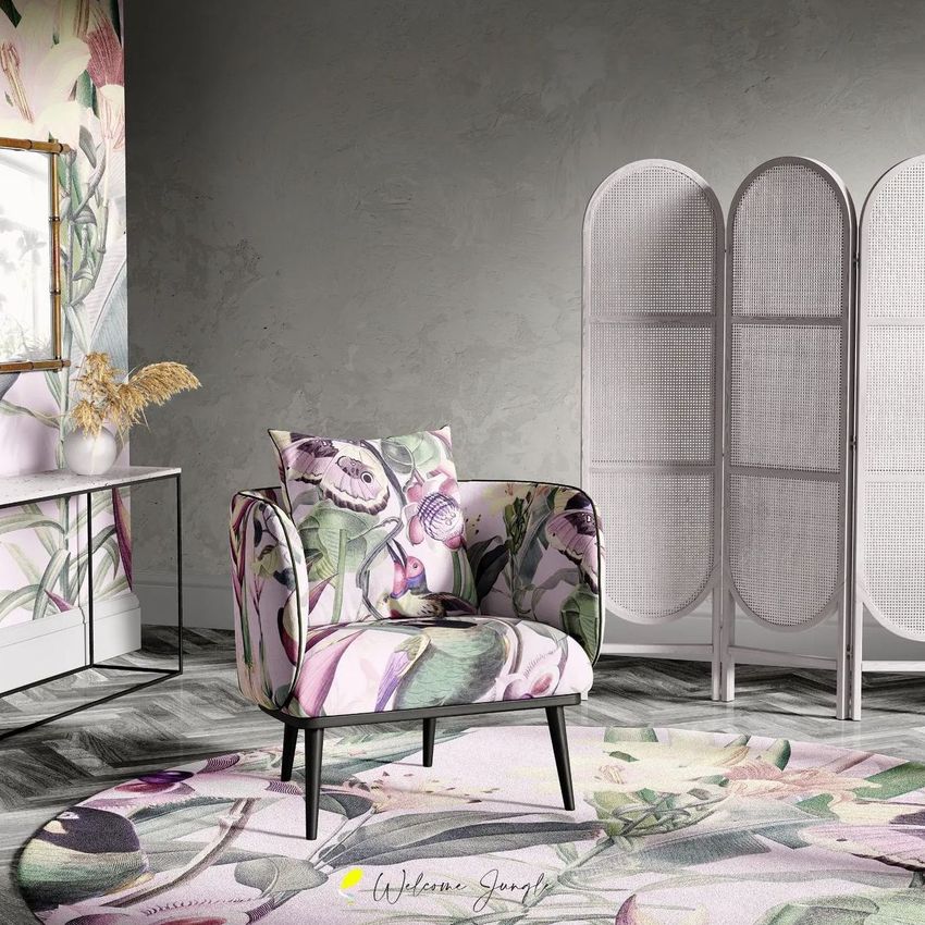 Armchair mockup in a sitting corner with floral upholstery, placed on a patterned rug beside a folding room divider and a console table.