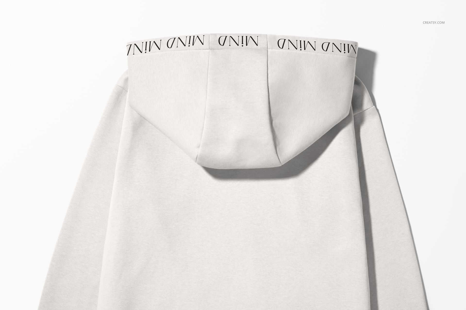 Oversized hoodie mockup in light beige color, viewed from the back, featuring a large hood with branded trim.