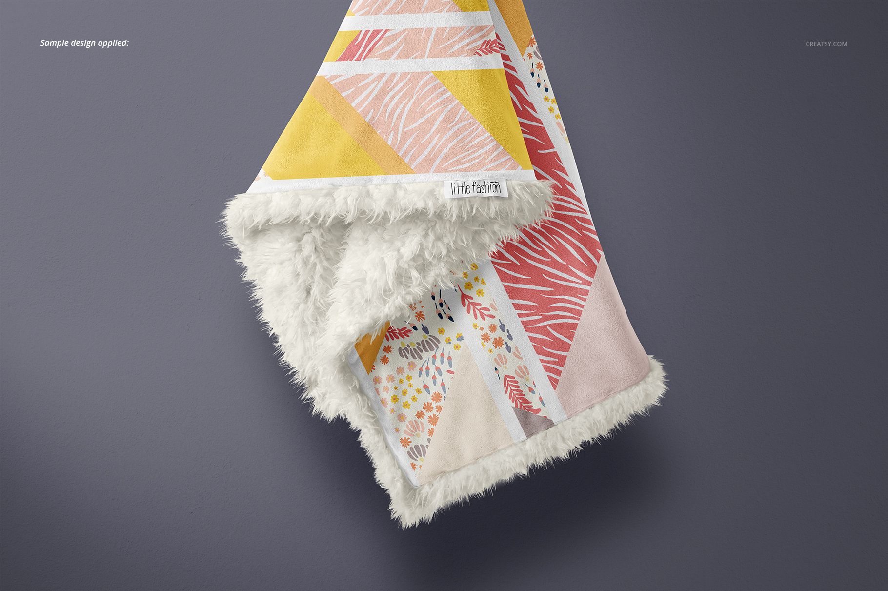 Folded sherpa baby blanket mockup displaying soft textured trim and colorful abstract designs, viewed from above on a neutral surface.
