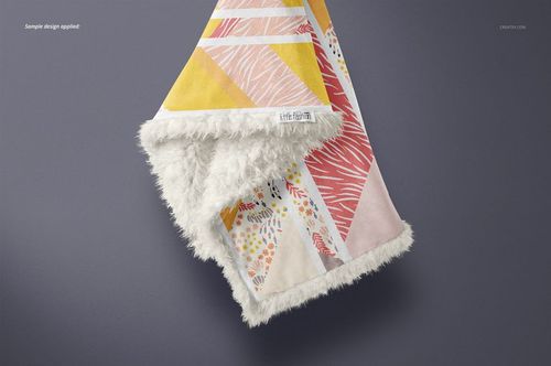 Folded sherpa baby blanket mockup displaying soft textured trim and colorful abstract designs, viewed from above on a neutral surface.