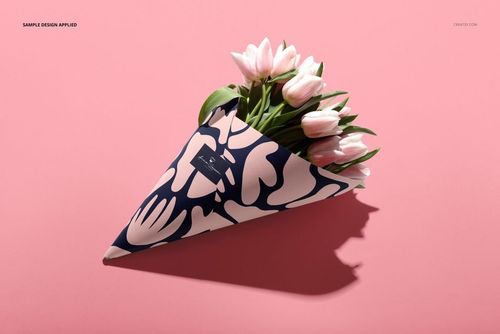 Flower packaging cone mockup featuring pink tulips in a paper cone with bold navy and white abstract pattern on pink background.