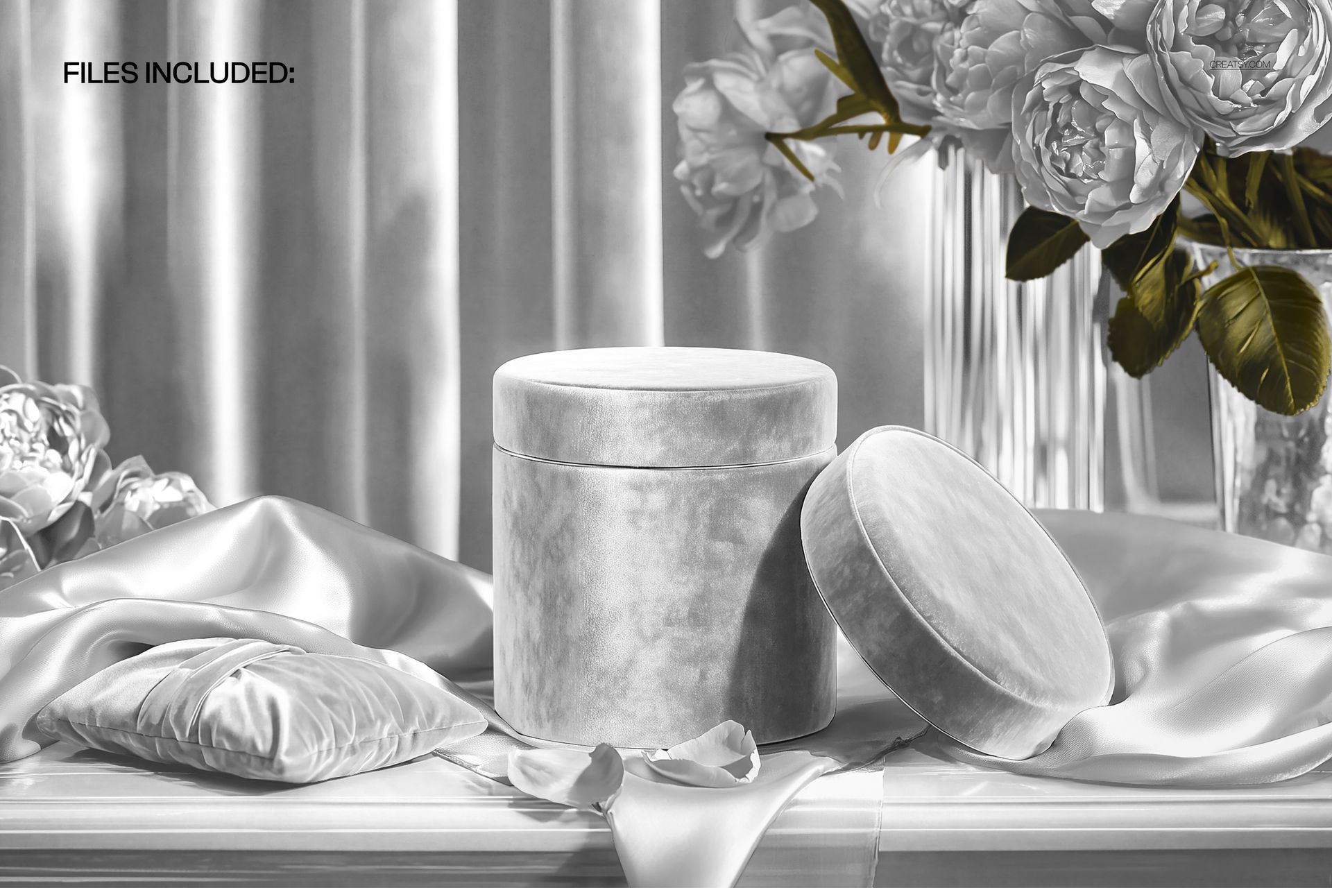 PSD mockup of a cylindrical gift box with removable lid, satin ribbon, and floral arrangement, shown from the front.