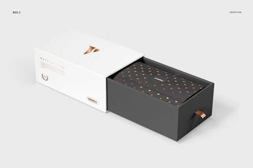Front view of a gift box mockup set showing a white sliding lid and a dark base with copper accents on a light background.