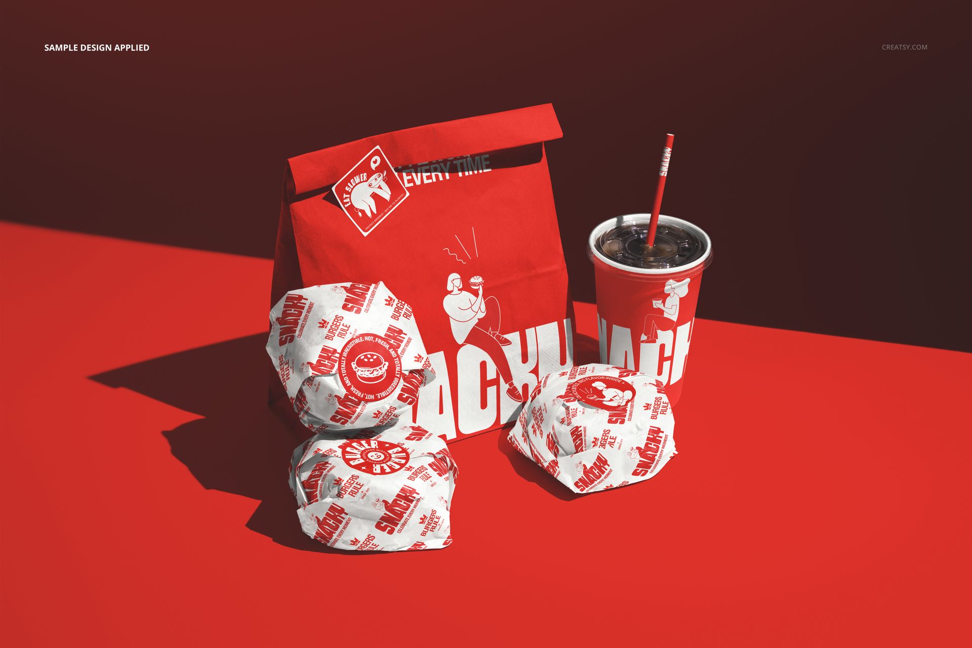 Fast food packaging mockup with two wrapped burgers, a red paper bag, and a drink cup with a straw on a red background.