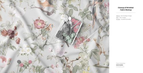 Close-up of a floral and bird print fabric mockup with gentle folds and a palette card placed on top.