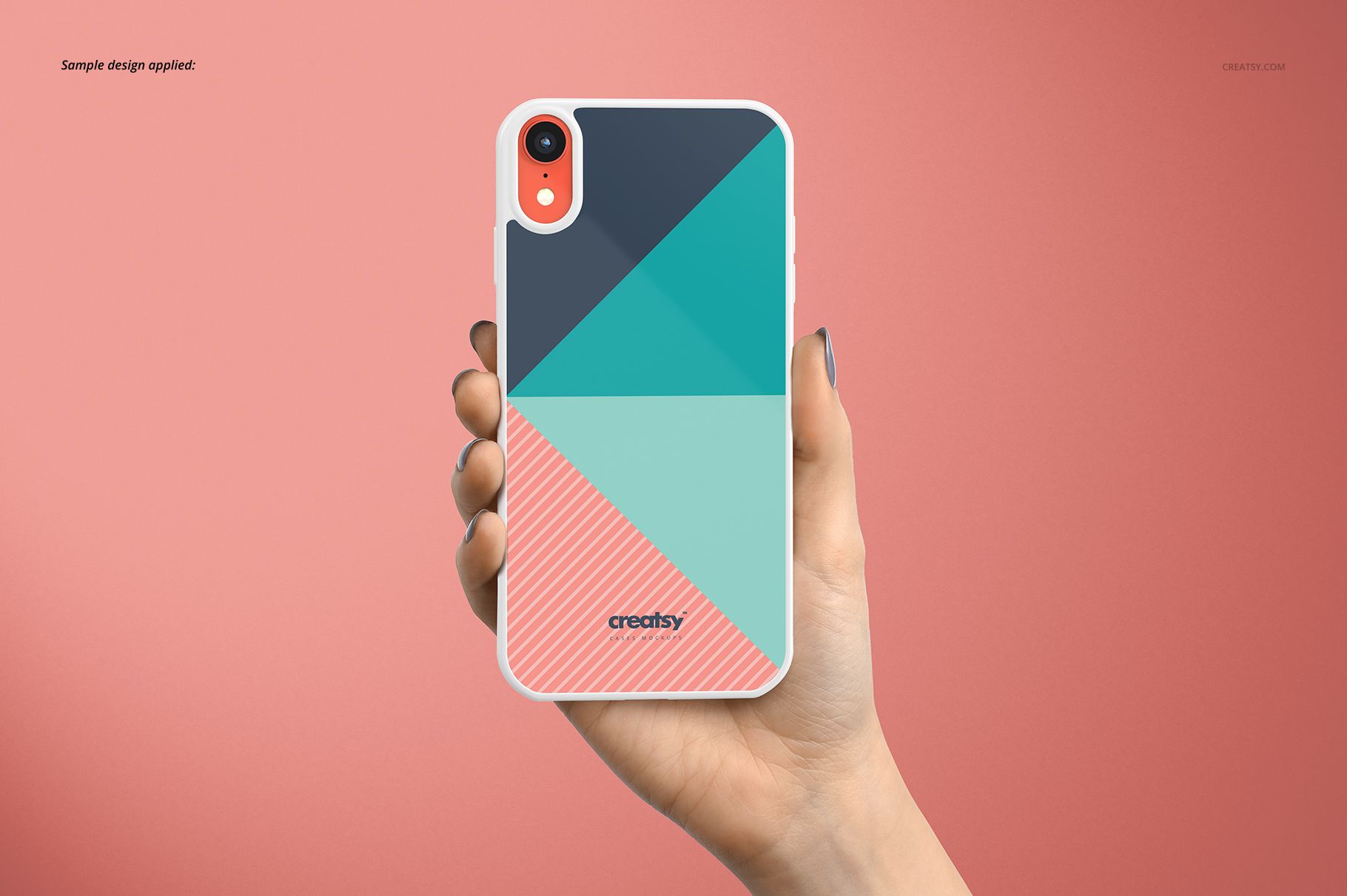 PSD mockup of a white iPhone XR case with colorful angular patterns, held upright by a hand on a pink surface.
