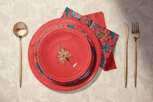 Ceramic plates mockup showing two red plates with intricate flower motifs, accompanied by a matching napkin and cutlery.
