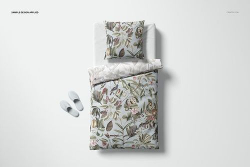 PSD mockup of a bedding set featuring a floral design, with duvet and pillow arranged neatly on a bed.