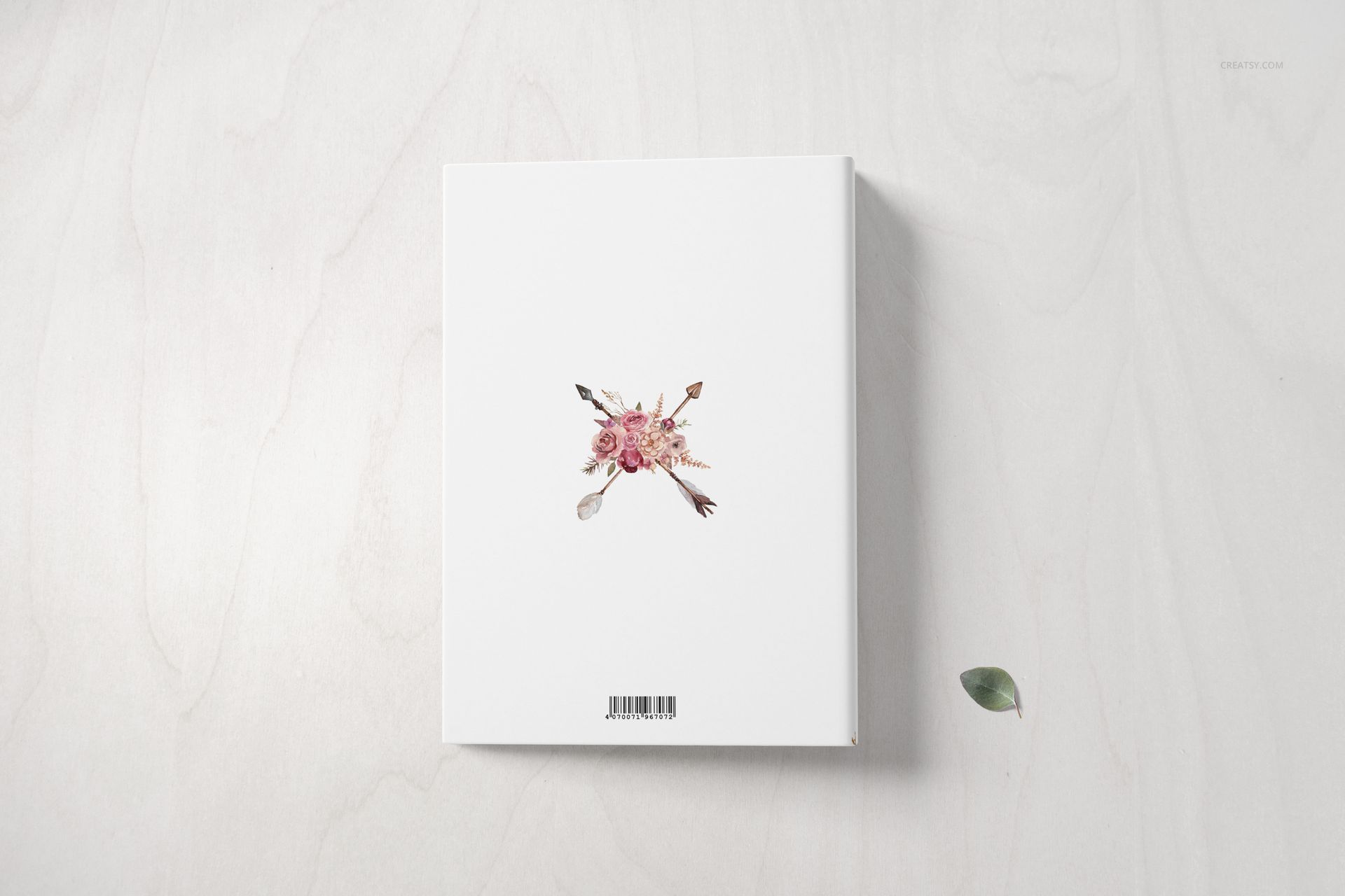 Family book mockup set displaying a white book cover with a central floral motif, viewed from a top-down perspective.