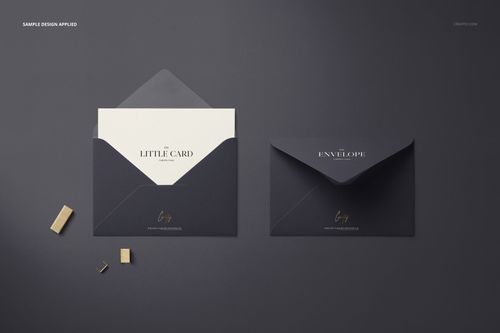 PSD mockup of a stationery set with a small envelope and card in black and white, shown from above on a dark background.