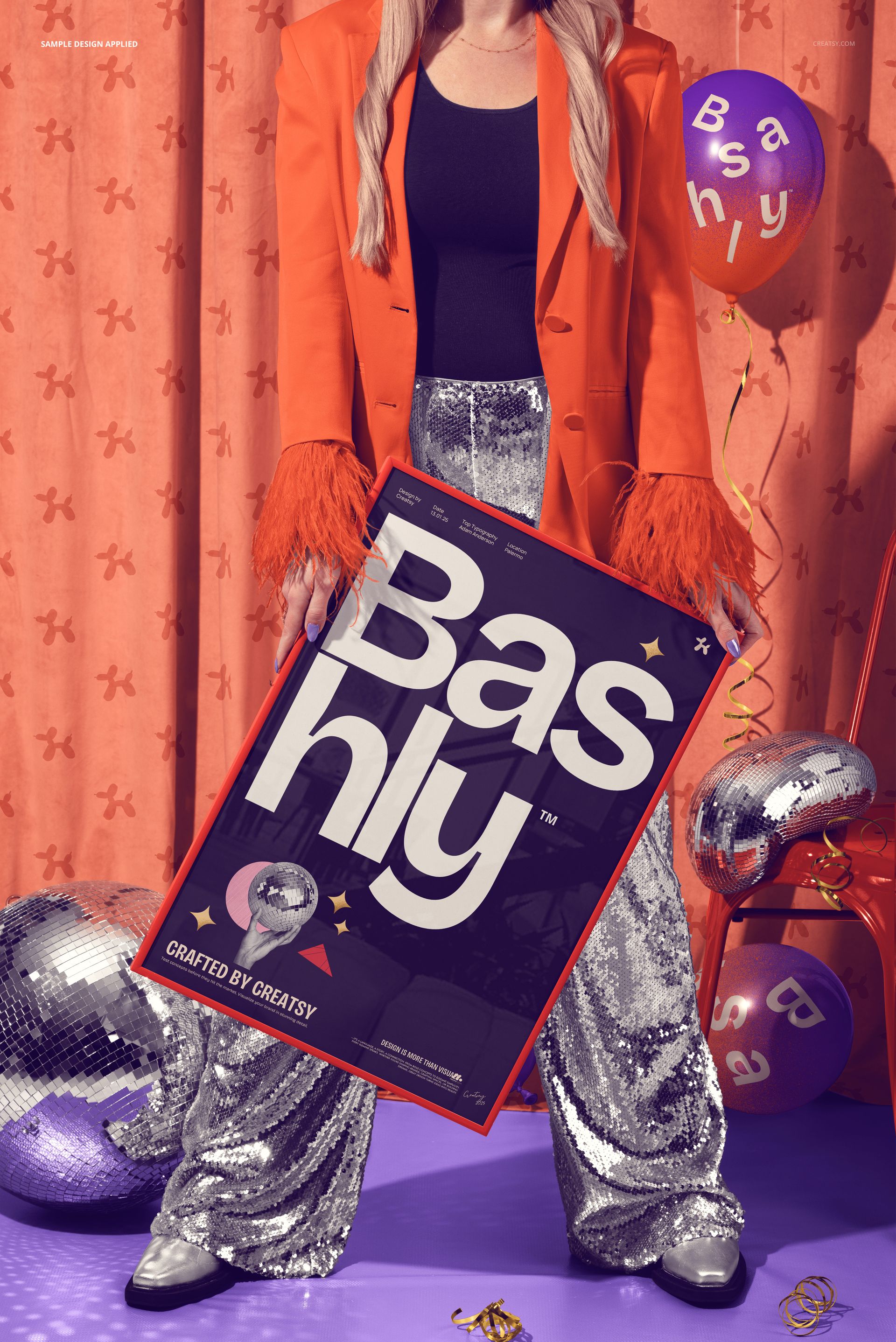 Person in a bright orange jacket and silver sequin pants holding a framed poster mockup at a disco-themed party scene.