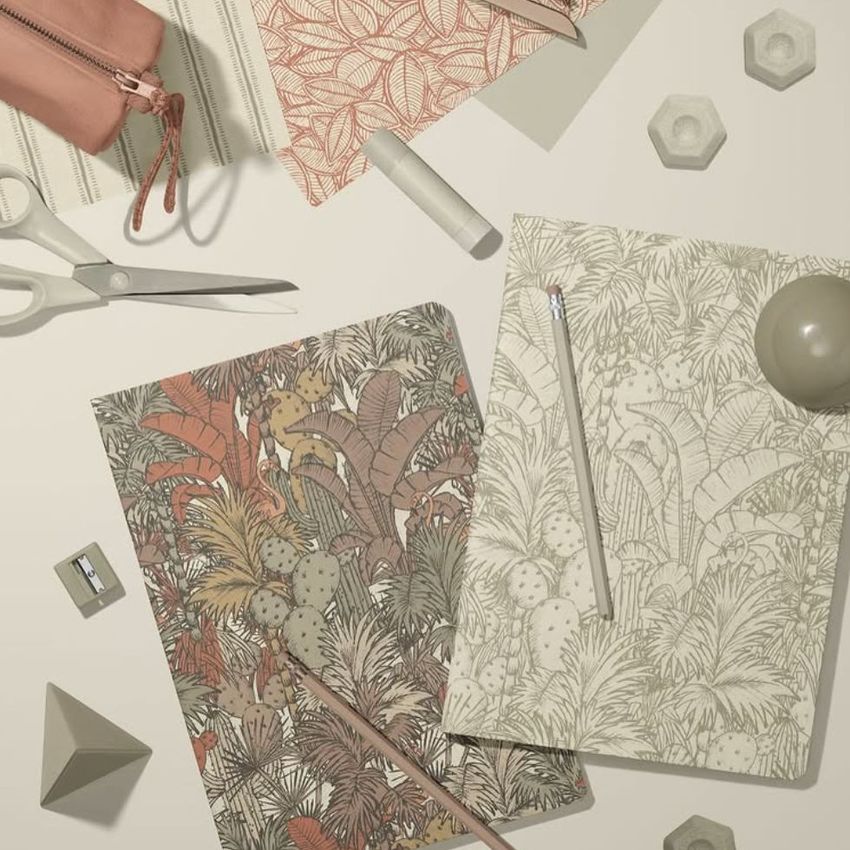Stationery mockup featuring two classic A4 notebooks with botanical covers, surrounded by pencils, scissors, and geometric props.