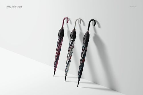 Umbrella mockup featuring trio of closed umbrellas in assorted colors and patterns, leaning against a plain white background.