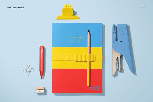 Stationery mockup featuring a notebook with bold horizontal stripes, pencil, stapler, pen, clip, and eraser arranged neatly.