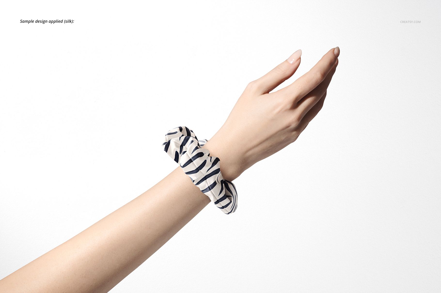Close-up of a hand wearing a striped hair scrunchie, shown in a PSD mockup with a clean white backdrop.