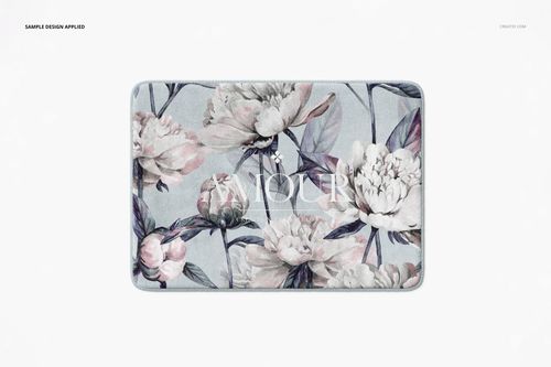 Rectangular plush bath rug with a soft floral pattern in pastel tones, shown in a front-facing PSD mockup scene.