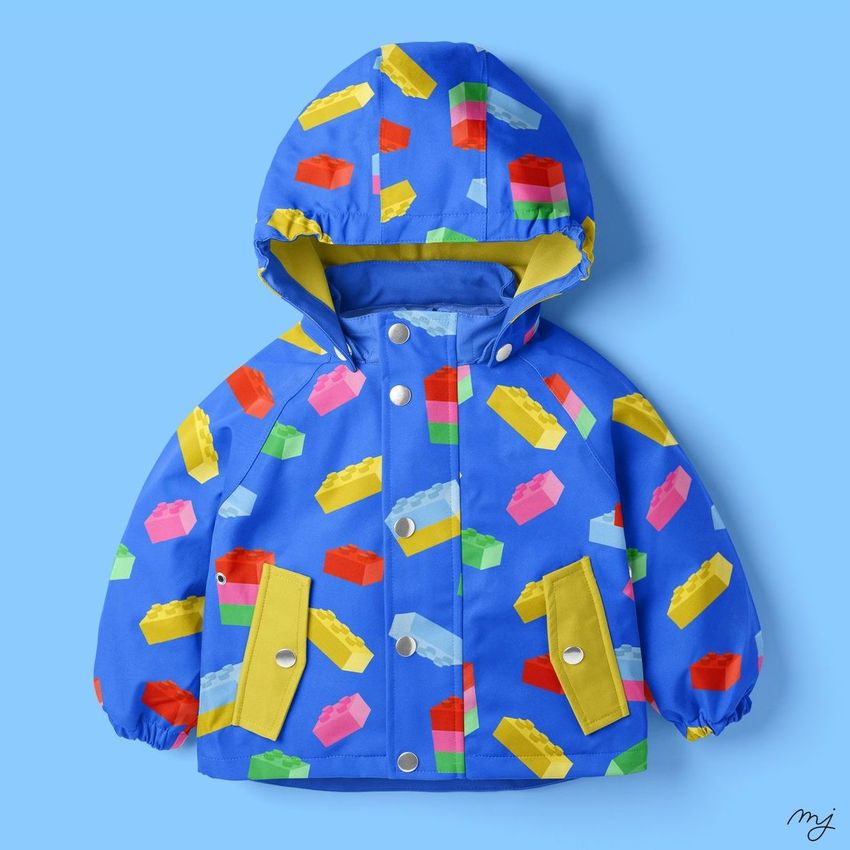 Kids rainwear mockup featuring a blue hooded jacket with colorful building block patterns on a solid light blue background.