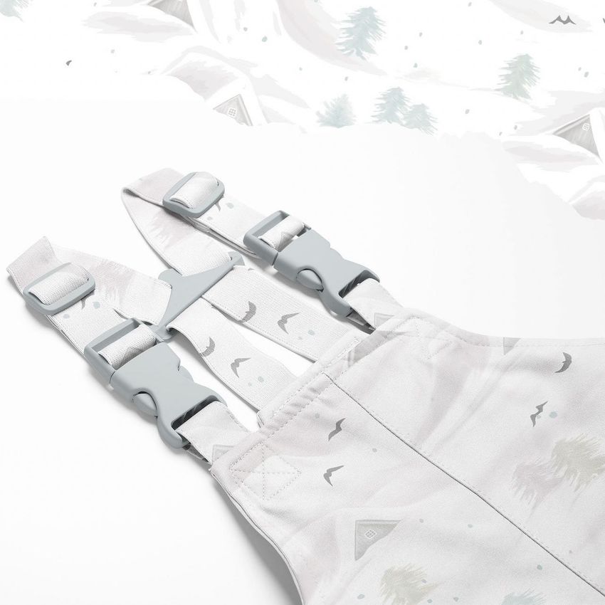 Kids rainwear mockup featuring light-colored overalls with adjustable straps and subtle arctic-inspired patterns on a white background.