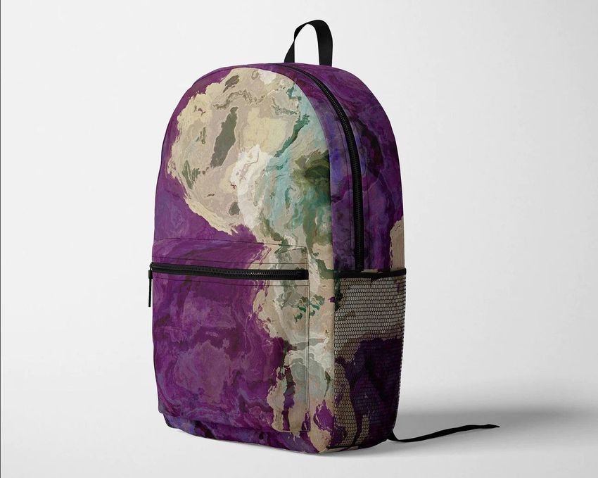 Polyester backpack mockup featuring a purple and beige abstract pattern, displayed at a three-quarter angle on a plain background.