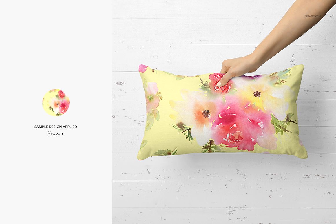 PSD mockup showing a rectangular pillow with pink and green flower prints, presented on a white wood backdrop.