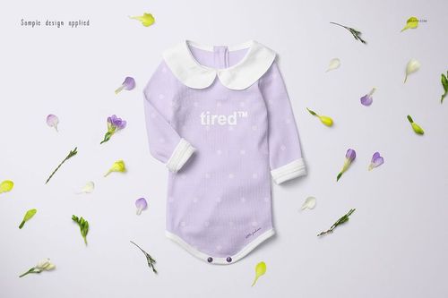 Long-sleeve baby romper mockup in light purple with white polka dots, front view, surrounded by flower petals.