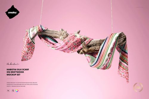 PSD mockup featuring a patterned silk scarf wrapped around driftwood, with a light pink background and decorative details.