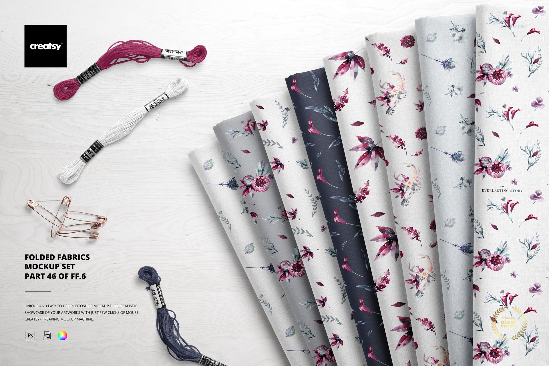 Folded fabrics with floral and botanical patterns displayed in a row on a light wooden surface, viewed from above.