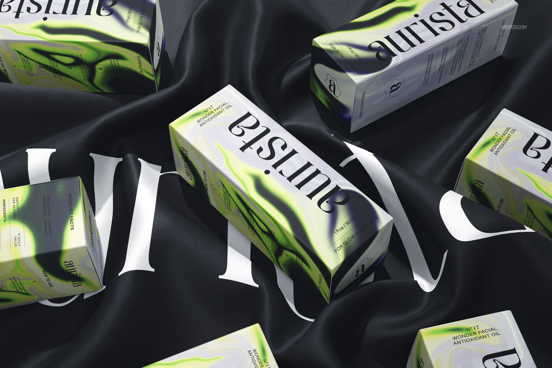 Dropper bottle mockup boxes featuring green accents and bold branding displayed atop a flowing black fabric.