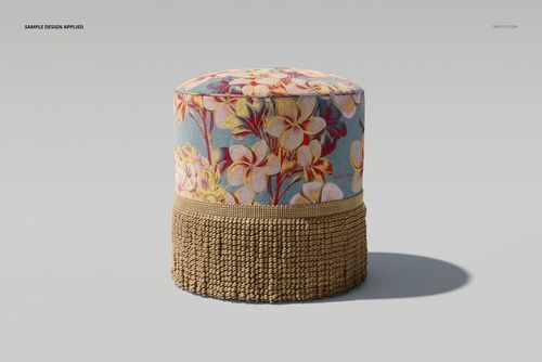 Round velvet footstool mockup with beige fringe, featuring a floral pattern in yellow and pink on a blue background.