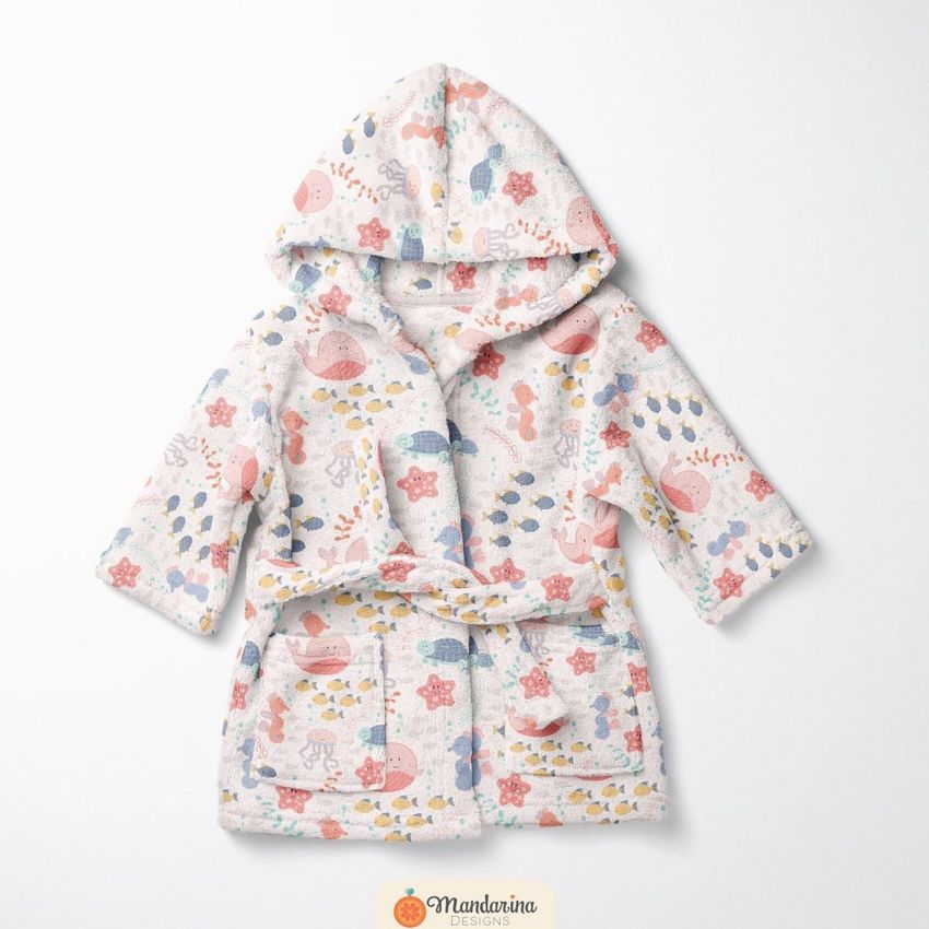 Baby bath dressing gown mockup featuring a hooded robe with colorful sea animal patterns on a white background, displayed flat.