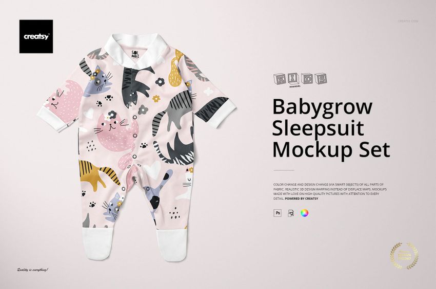 Front view of a babygrow sleepsuit mockup with playful cat and paw print patterns in pastel colors on a light background.