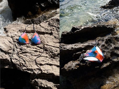 Colorful bikini mockup set displayed on rocky outdoor coastline, featuring vibrant patterns and natural sunlight.